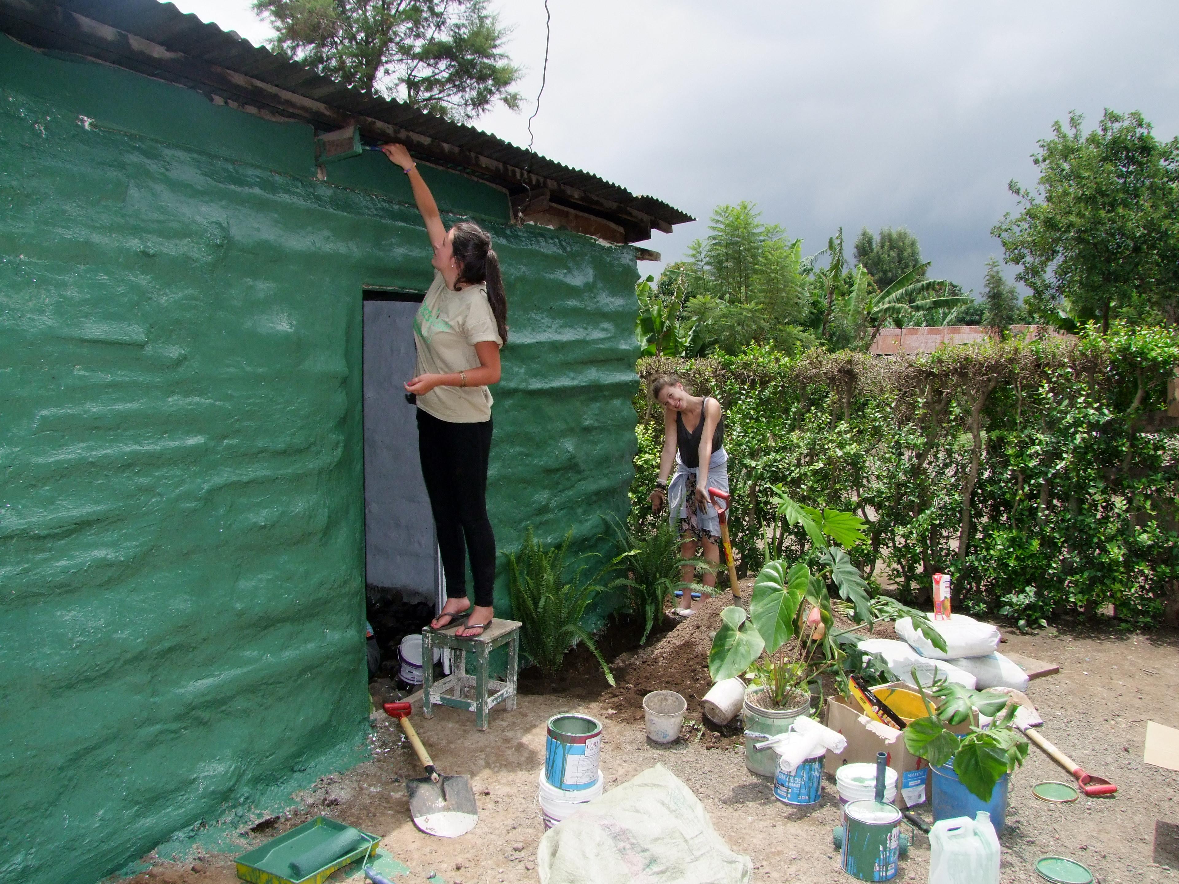 A female Projects Abroad volunteer assists with building a new home for a local family whilst on her building volunteer work in Tanzania Seen here is a female Projects Abroad volunteer assisting with building a home for a local family during her building volunteer work in Tanzania